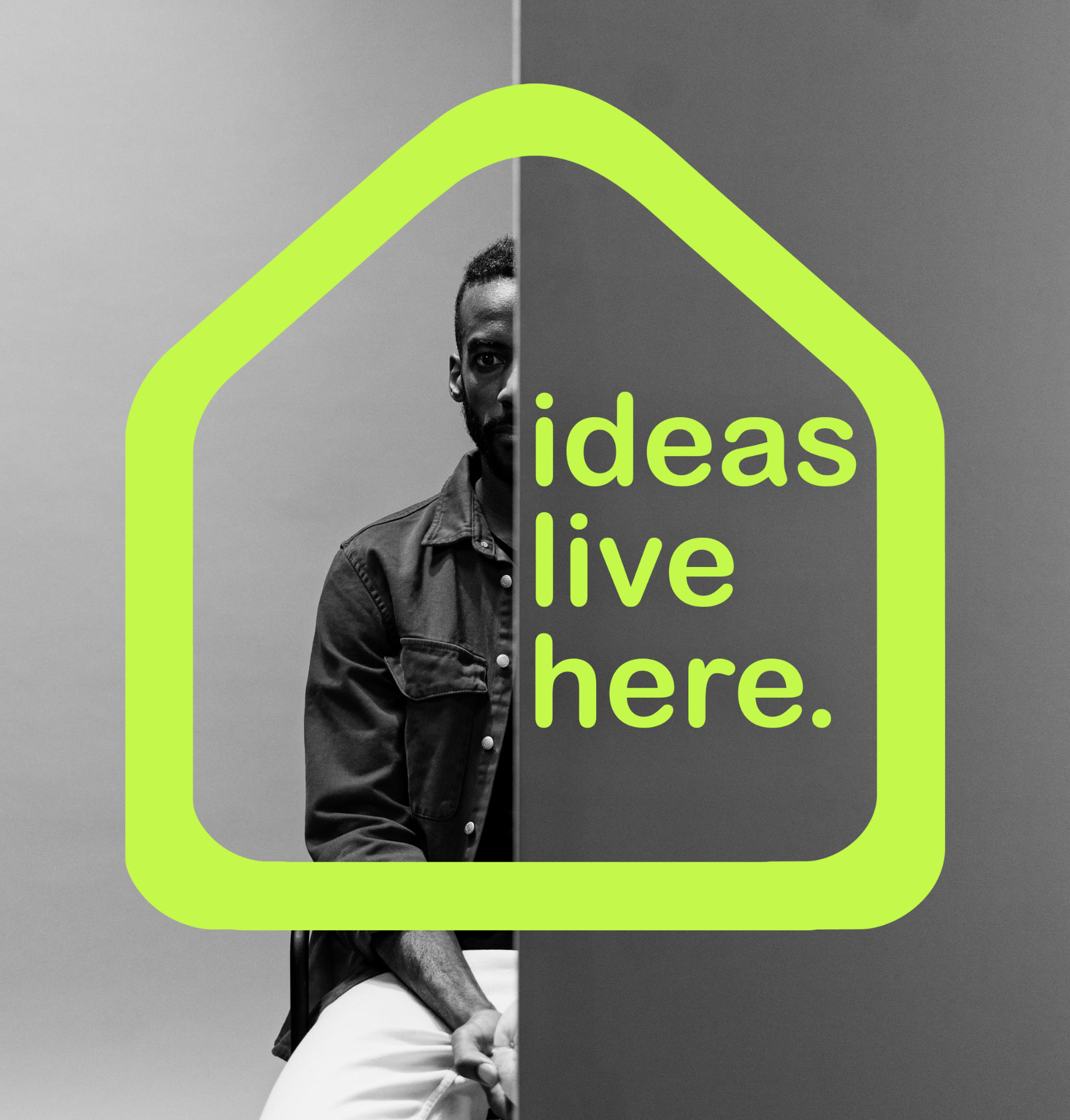 A Black creative behind a bold lime house frame with the words ideas live here